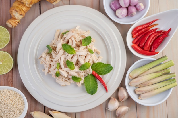 Foto gratuita el pollo bordeado se cocina y se coloca en un plato blanco junto con hojas de menta.