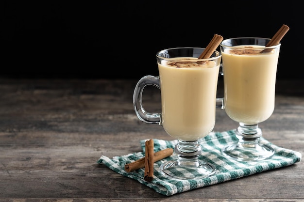 Foto gratuita ponche de huevo casero con canela sobre mesa de madera postre típico de navidad cerrar