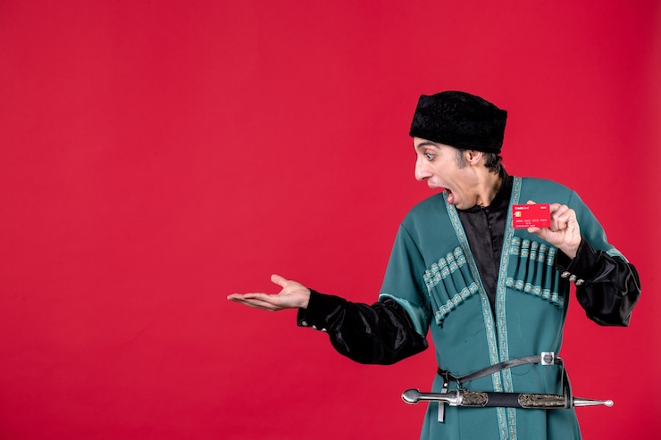 Photo Gratis portrait of azeri man in traditional costume holding credit card on red money ethnic novruz