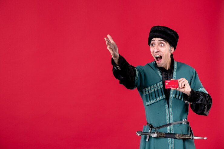 Photo Gratis portrait of azeri man in traditional costume holding credit card studio shot red spring ethnic novruz