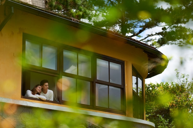 Posibilidad muy remota de la pareja que mira por la ventana de su nueva casa