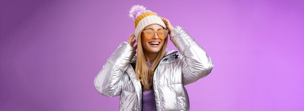 Foto gratuita sin preocupaciones, divertida, encantadora novia rubia, divirtiéndose disfrutando de una increíble estación de esquí en un día soleado de invierno.