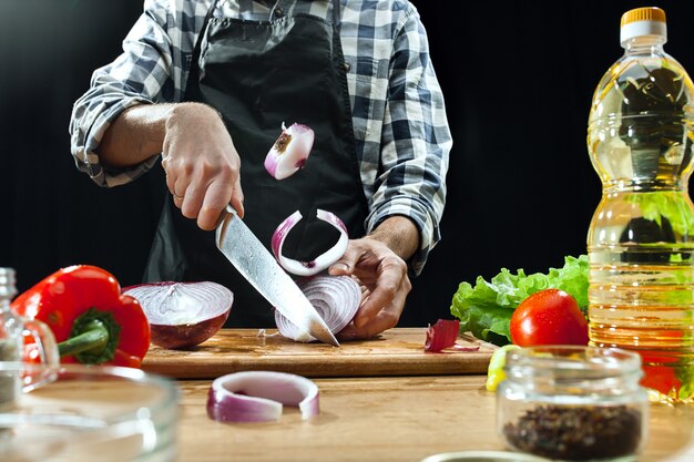 Preparando ensalada. Chef mujer cortando verduras frescas. Proceso de cocción. Enfoque selectivo