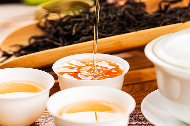 Foto gratuita preparando té chino en gaiwan de cerámica durante el primer plano de la ceremonia del té