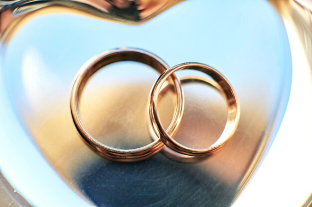 Primer plano de los anillos de bodas en la placa de oro