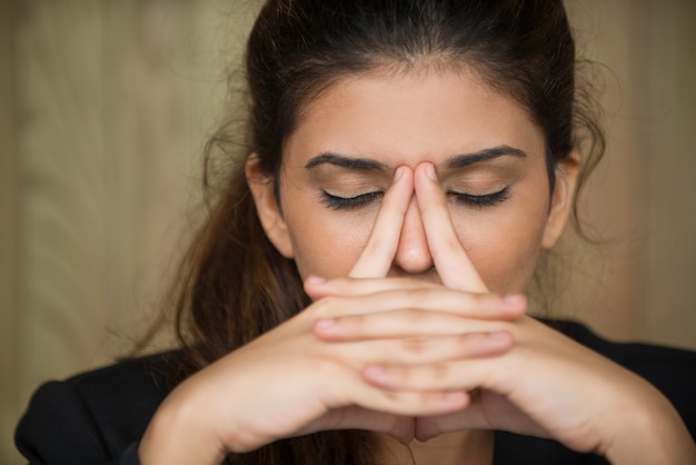 Primer plano, cansado, joven, mujer, frotar, nariz