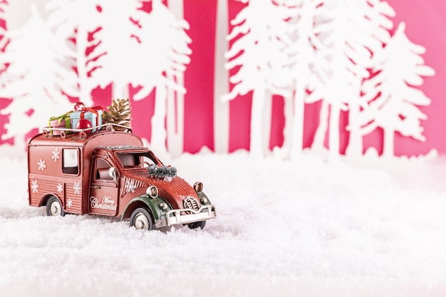 Primer plano de un coche de juguete para la decoración navideña en la nieve