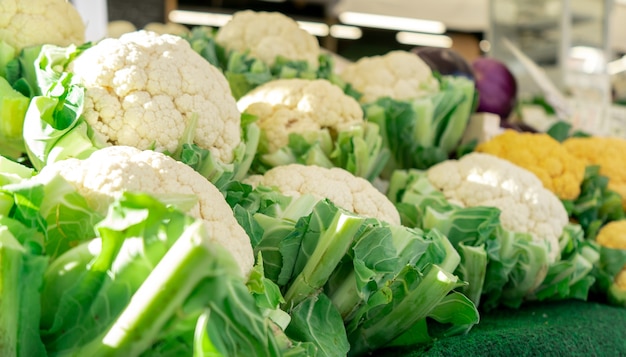 Primer plano de coliflor dispuestas en una tienda de comestibles