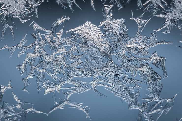 Foto gratuito primer plano de un copo de nieve en un vaso de escarcha, con patrón detallado