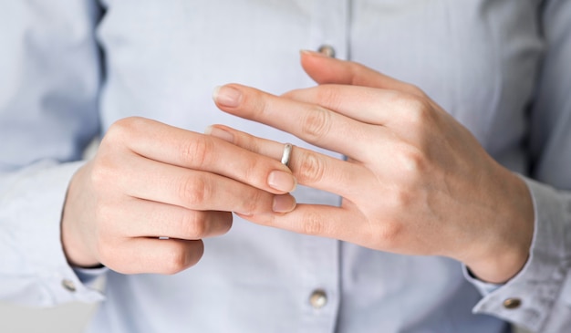 Primer plano femenino tirando anillo de matrimonio