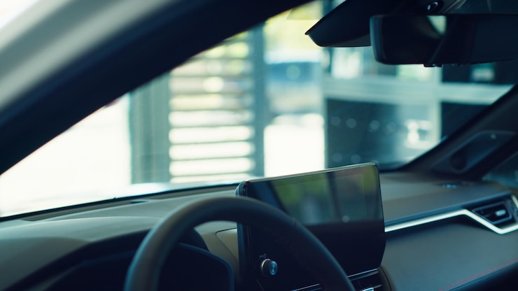 Foto gratuito primer plano del interior del coche con el volante y la pantalla del sistema de infoentretenimiento