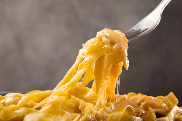 Primer plano de macarrones con queso derretidos