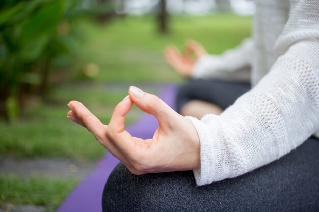 Primer plano de la mano femenina meditando al aire libre