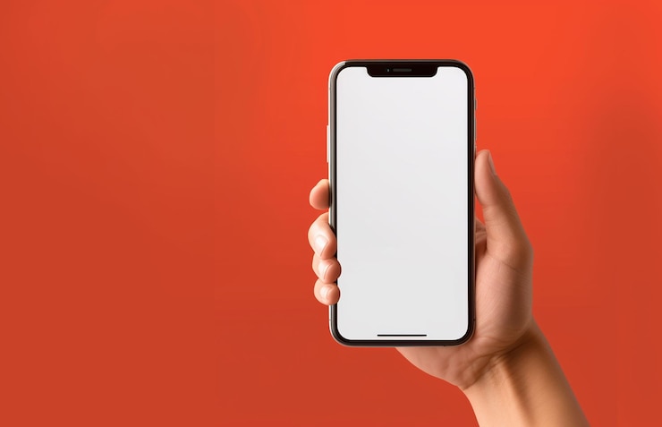 primer plano mano sujetando pantalla en blanco teléfono móvil en fondo naranja