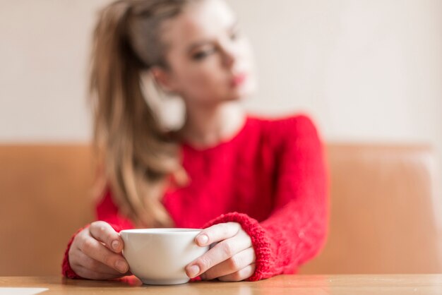 Primer plano de manos sujetando una taza