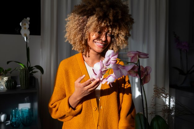 Primer plano de una mujer decorando su casa con orquídeas