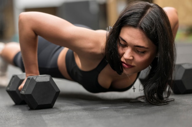 Foto gratuita primer plano de mujer entrenando con pesas