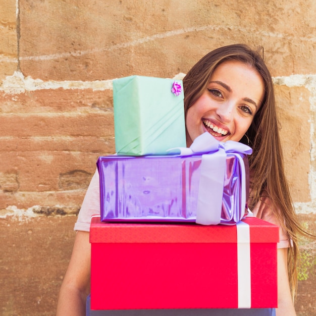 Foto gratuita primer plano de una mujer feliz con regalos apilados