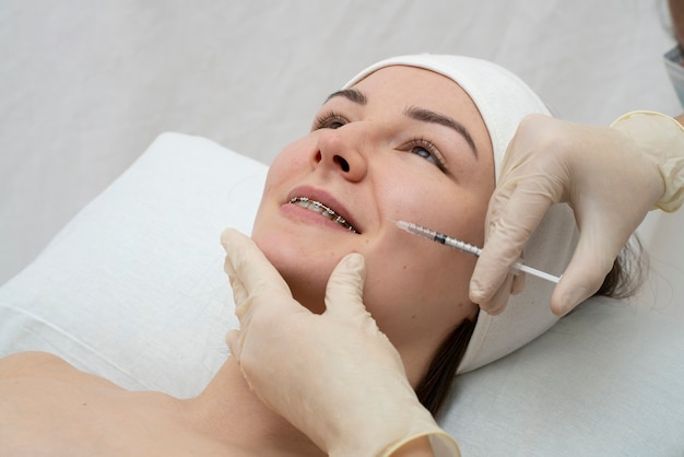 Foto gratuita primer plano de la mujer durante el procedimiento de relleno de labios