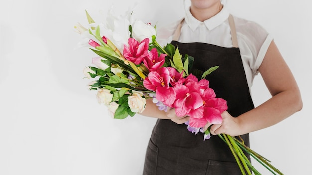 Primer plano de una mujer sosteniendo un ramo de flores blancas y rojas