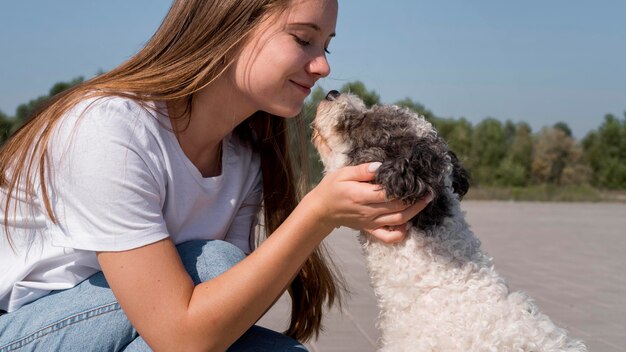 Primer plano, niña, tenencia, cabeza de perro