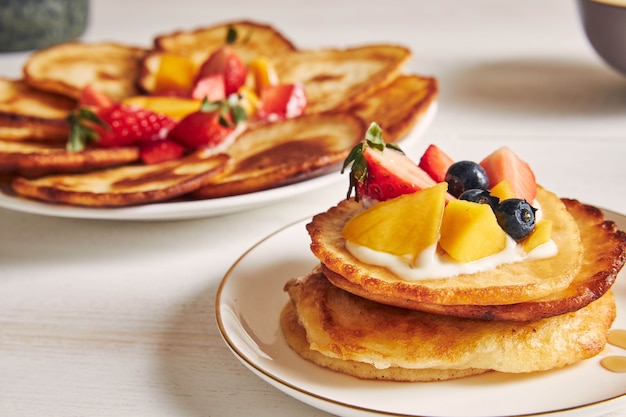 Primer plano de panqueques con frutas en la parte superior en el desayuno