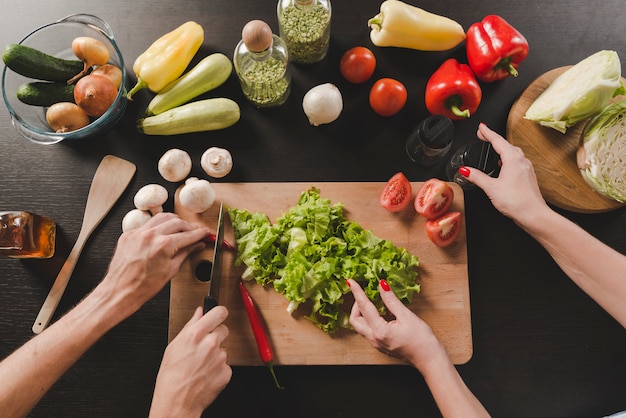 Primer plano de la pareja preparando la comida en el mostrador de la cocina