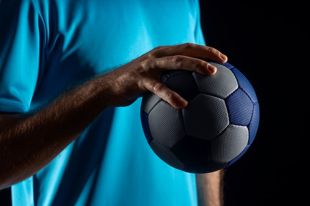 Primer plano con una pelota de balonmano en la mano