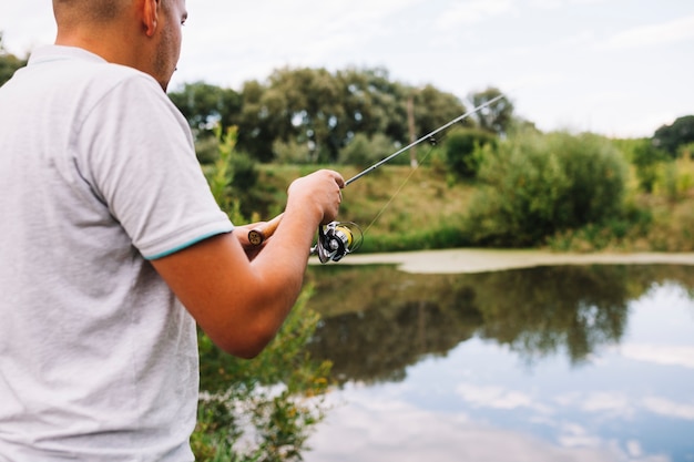 Primer plano de un pescador que pesca en el lago