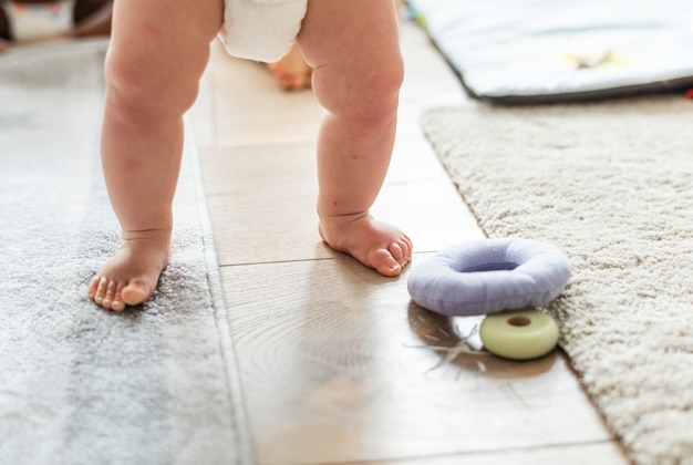 Primer plano de las piernas del bebé mientras está de pie