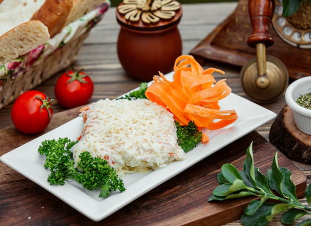 Un primer plano de plato de ensalada de mimosa con queso holandés en la parte superior