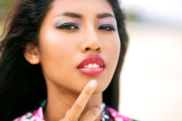Primer plano retrato de mujer asiática sensual con maquillaje brillante, piel de belleza, aspecto moderno.