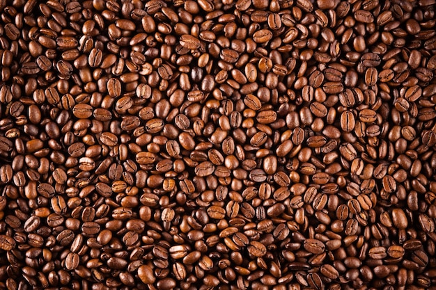 Primer plano de la textura de los granos de café. Café marrón, textura de fondo, primer plano. Bonito fondo para tus ideas.