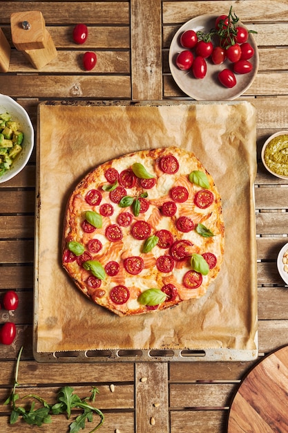 Foto gratuita primer plano vertical de una pizza con verduras en la mesa de madera