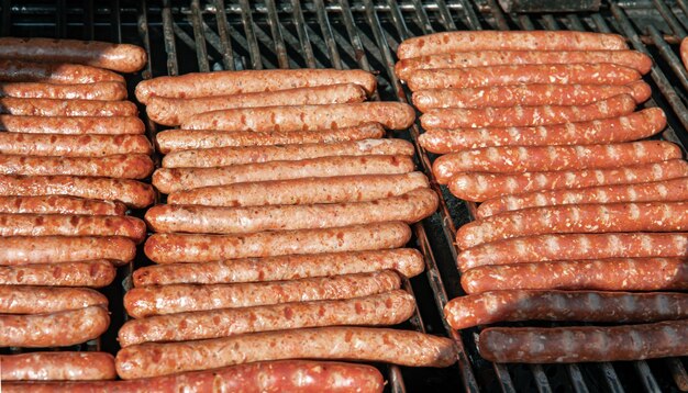 El proceso de asar a la parrilla las salchichas de caza en la naturaleza.