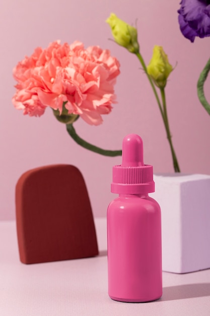 Foto gratuita producto cosmético y arreglo floral.