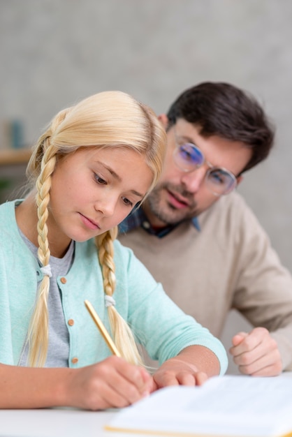 Foto gratuita profesor y joven estudiante enfocados