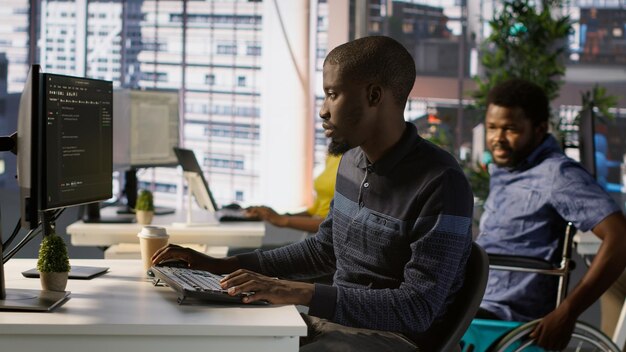 Programmer doing software debugging asking for help from smiling team leader