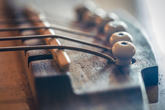 Puente de guitarra acústica y cuerdas de cerca