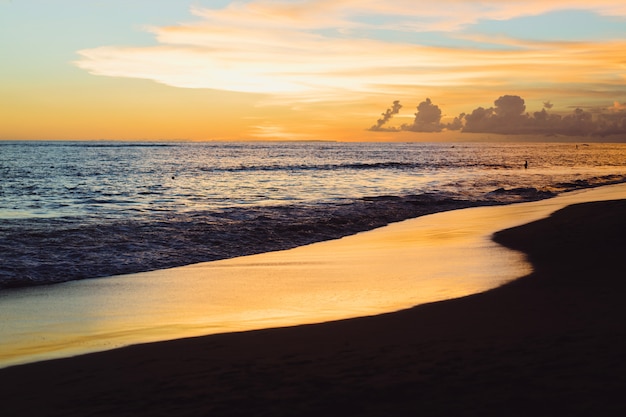 Foto gratuita puesta de sol en el océano. hermoso cielo brillante, reflejo en el agua, las olas.