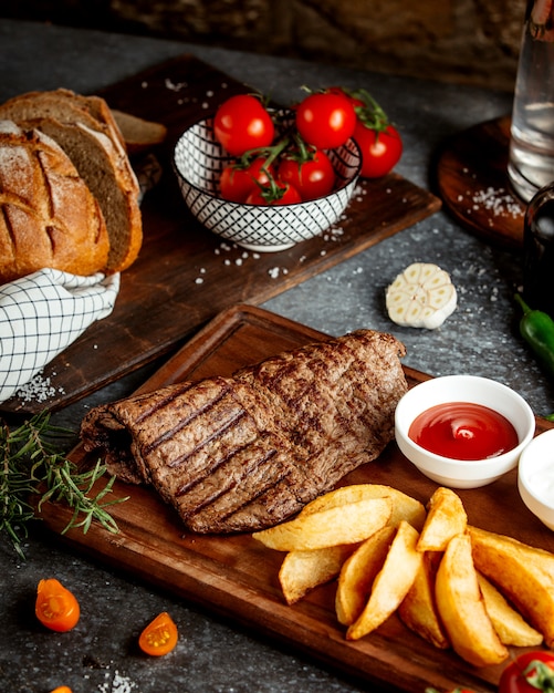 Rebanada de carne y papas asadas