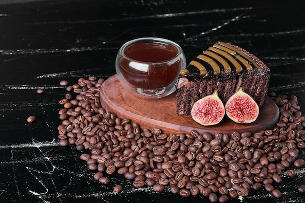 Rebanada de pastel de chocolate con una taza de bebida.