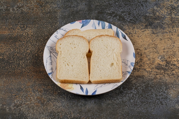 Foto gratuita rebanadas de pan tostado en placa colorida