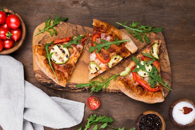 Rebanadas de pizza sobre tabla de madera vista superior