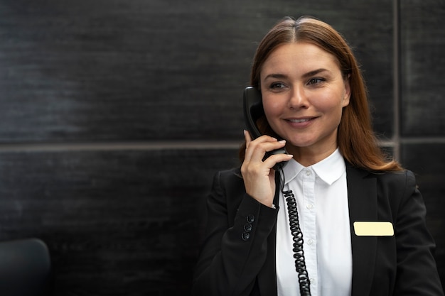 Recepcionista femenina con traje elegante durante las horas de trabajo