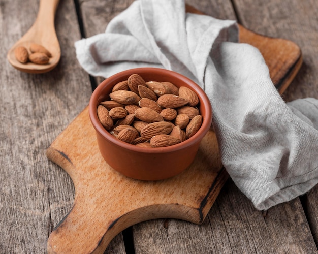 Recipiente lleno de almendras y paño de cocina