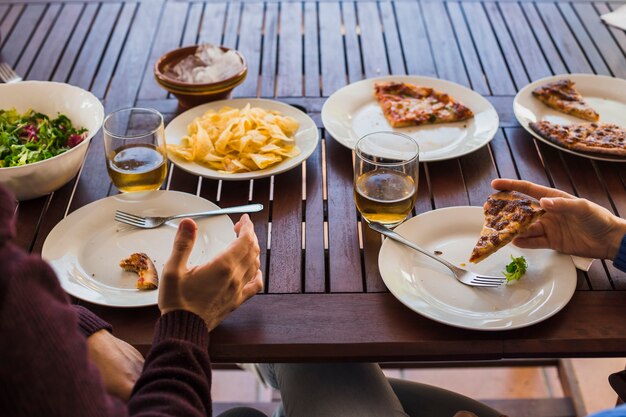 Recortar las manos del hombre y la mujer almorzando