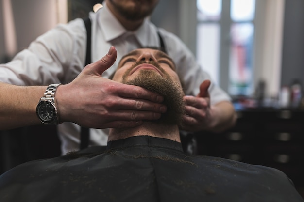 Recorte de peluquería labrar la barba del cliente