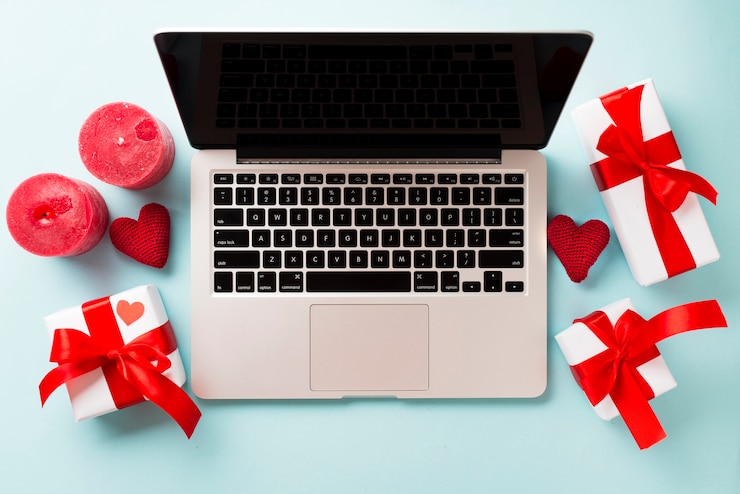 Foto gratuito regalos y velas cerca de la computadora portátil