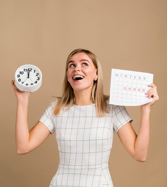 Reloj y calendario de época en manos de una mujer